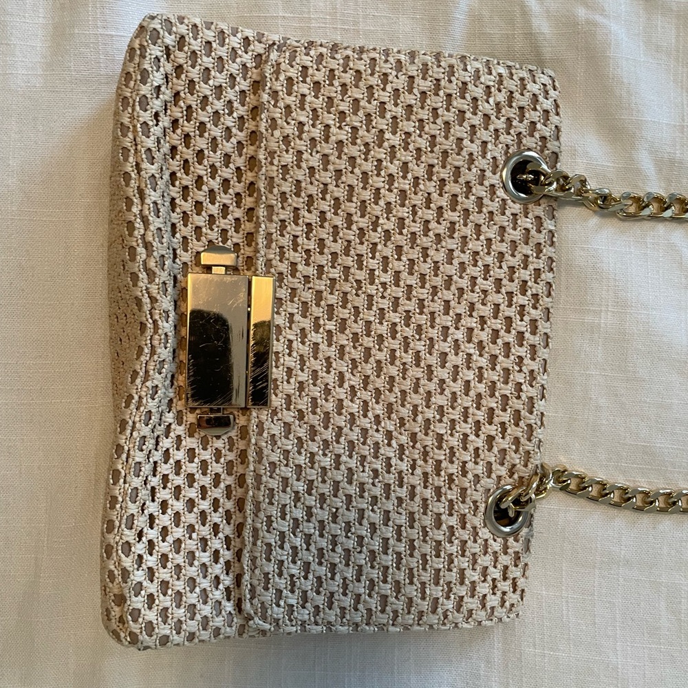 Aldo straw purse with gold details.